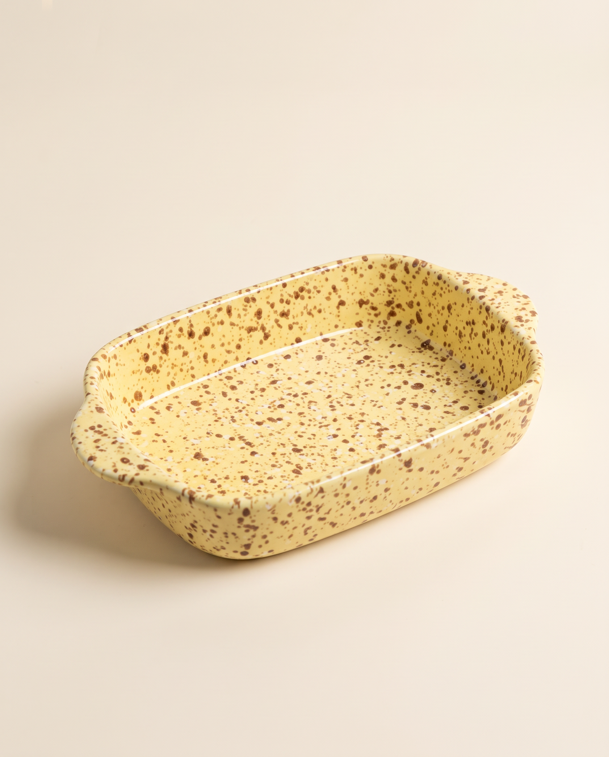 Splatterware ceramic baking dish in Custard glaze