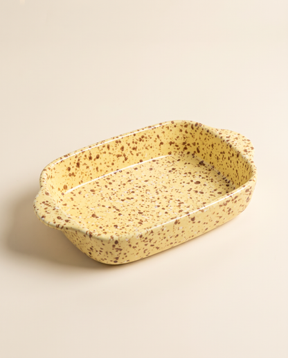 Splatterware ceramic baking dish in Custard glaze